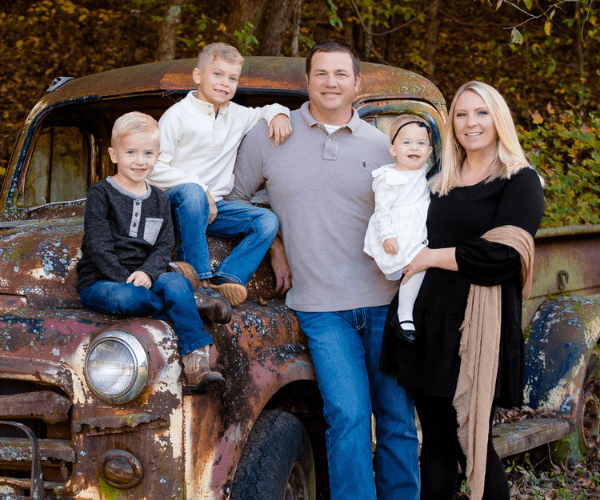 Family Photo Posing in Front of a Rustic Truck