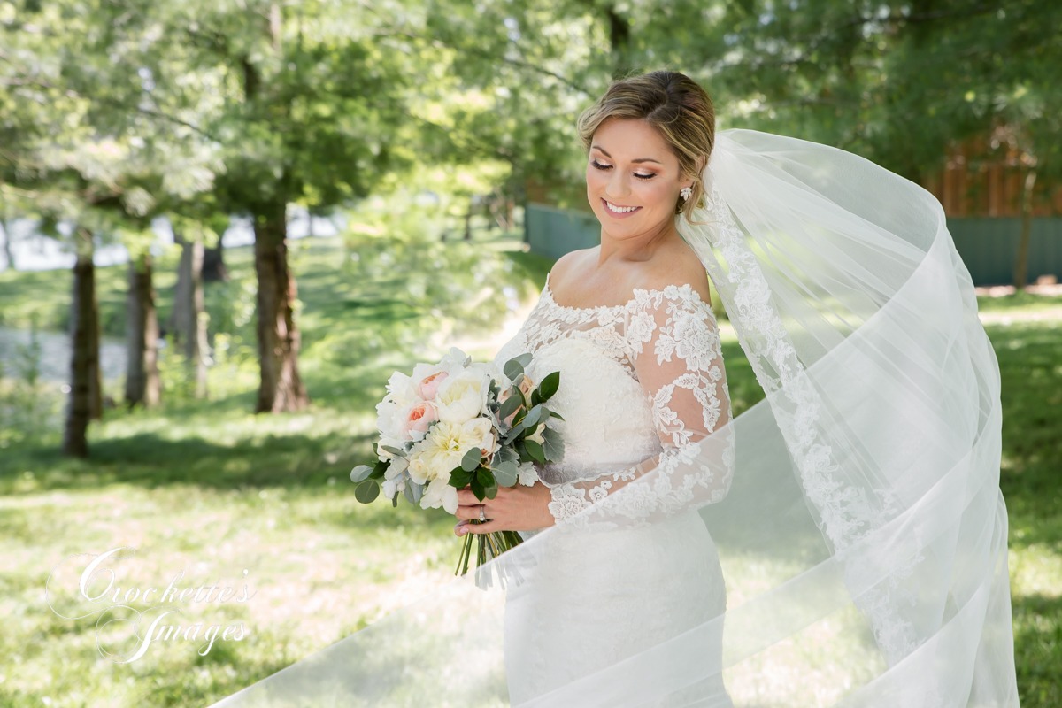 Bridal Portrait with long veil blowing in the wind at Waters Edge in Cape Girardeau. MO