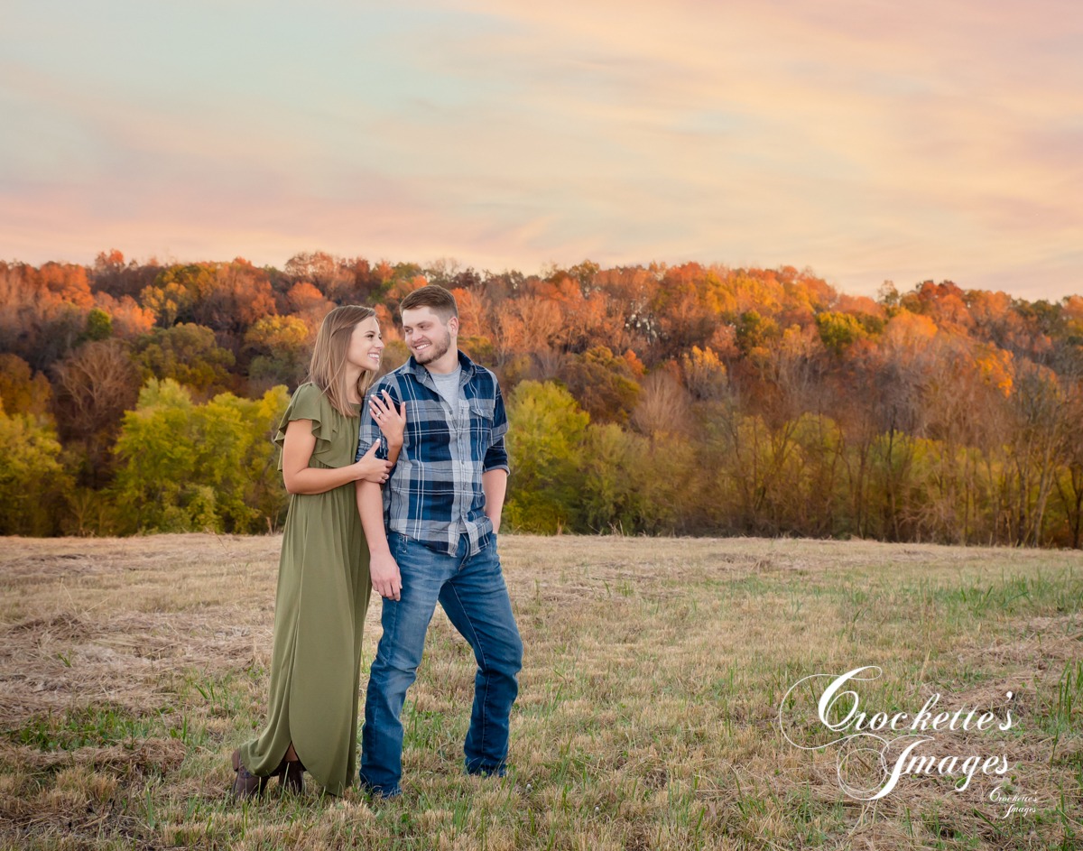 Fall engagement photo of couple on a ridge top at sunset