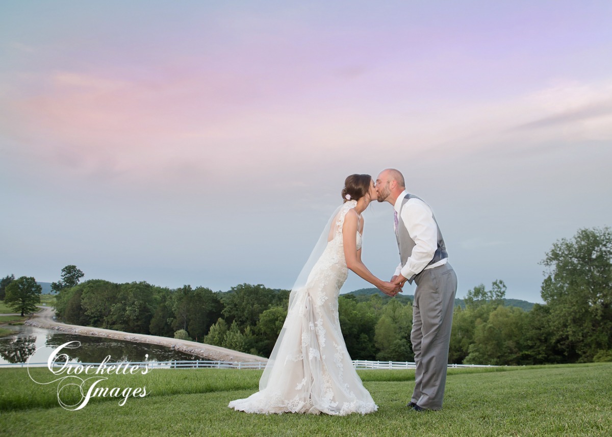 Wedding couple kissing at sunset at Chaumette Winery in Ste. Gen, MO.