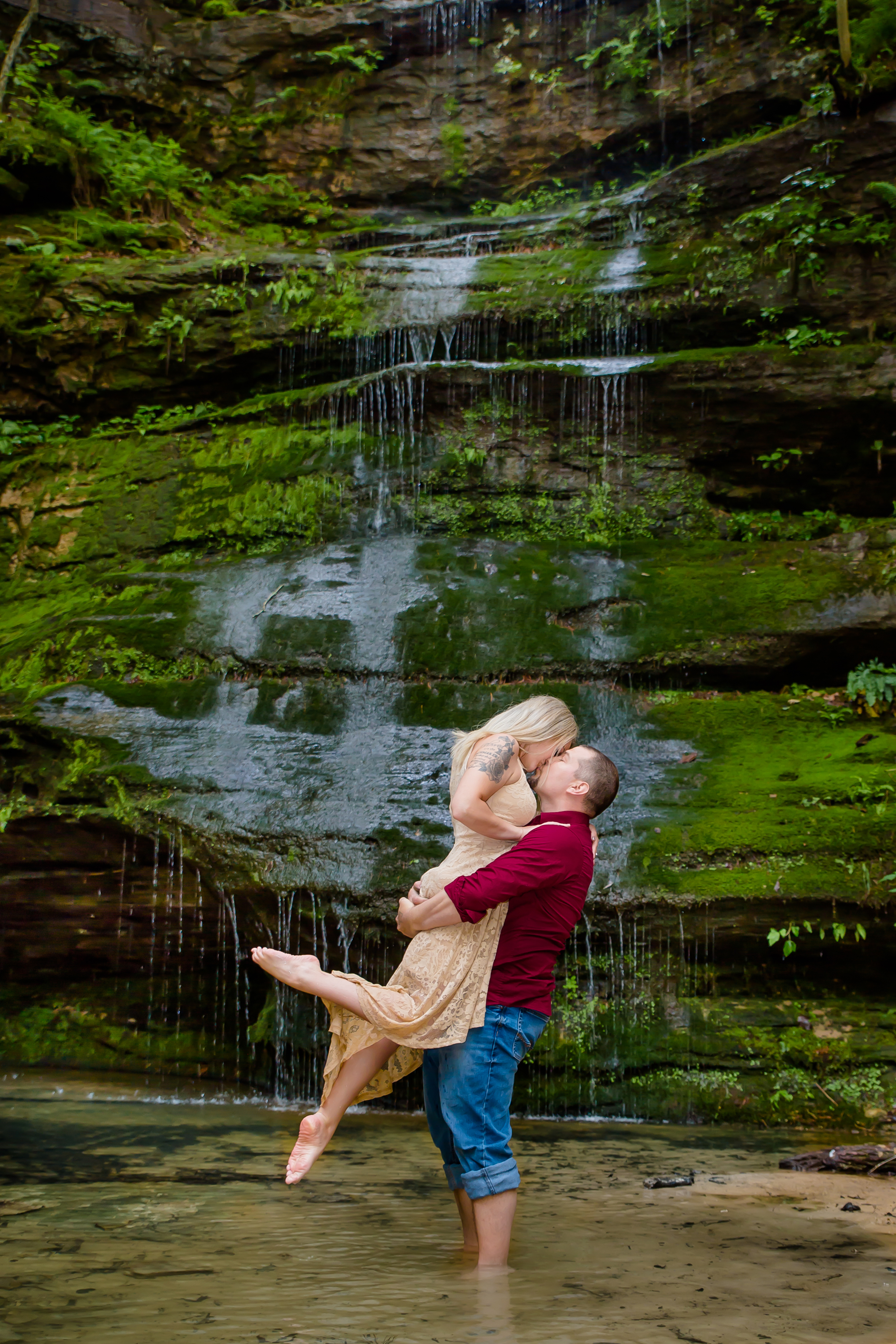 Romantic engagement photo at a waterfall