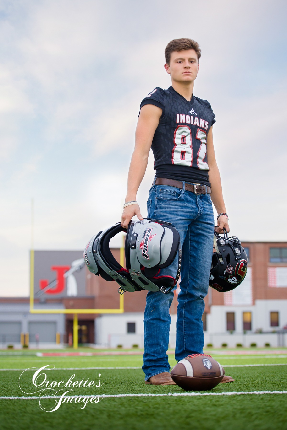 powerful football senior photo at sunset