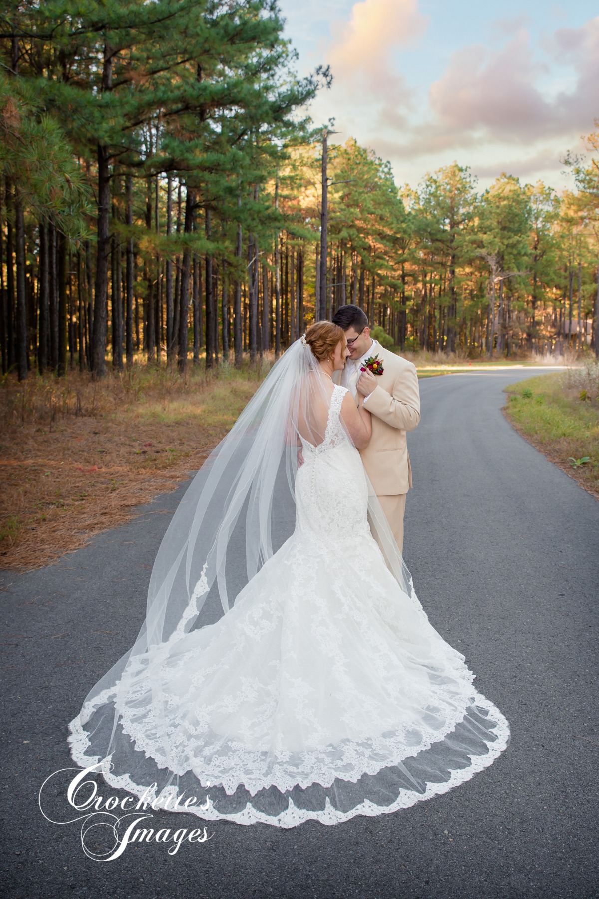 Wedding photo of a couple with the bride's veil blowing in the wind