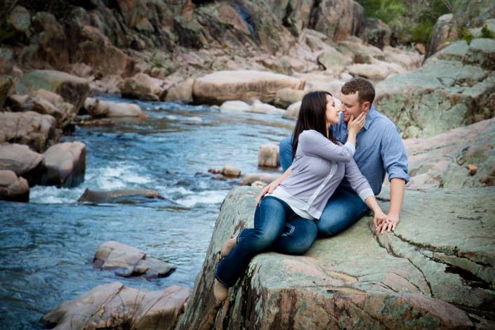 couple posing in romantic rocky creek