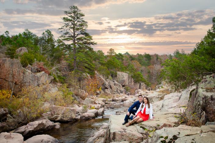 couple posing in rocky creek