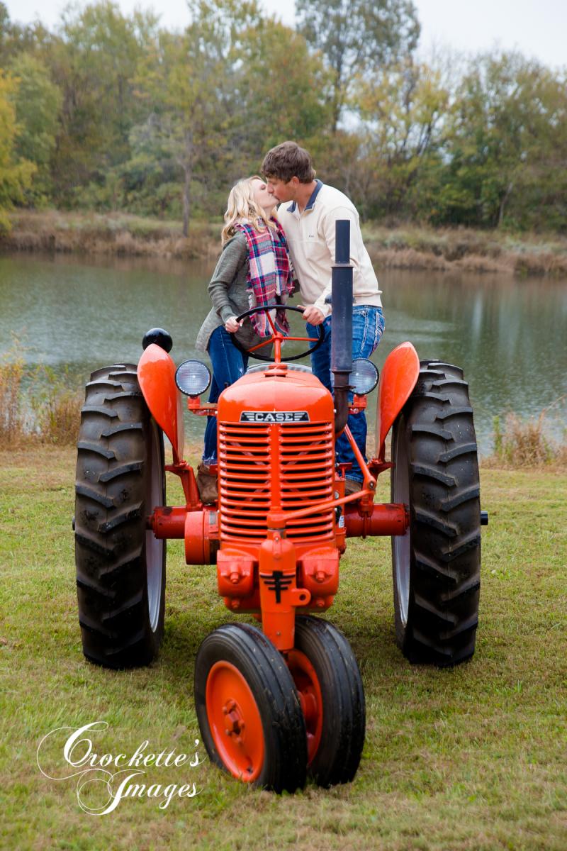 Romantic Emotional Fall Engagement Photo with a tractor. Tractor Engagement Photos. Country engagement photos with a tractor.