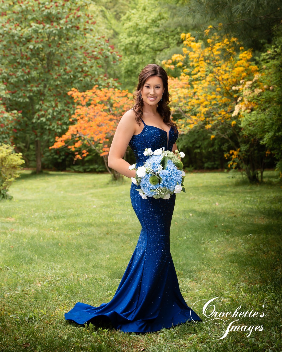 Senior Prom Photos with Navy Dress surrounded by flowers.