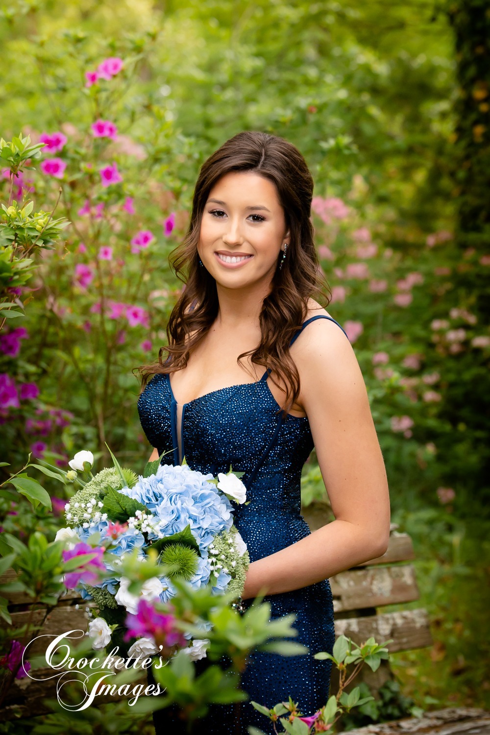 Senior Prom Photos with Navy Dress surrounded by flowers.