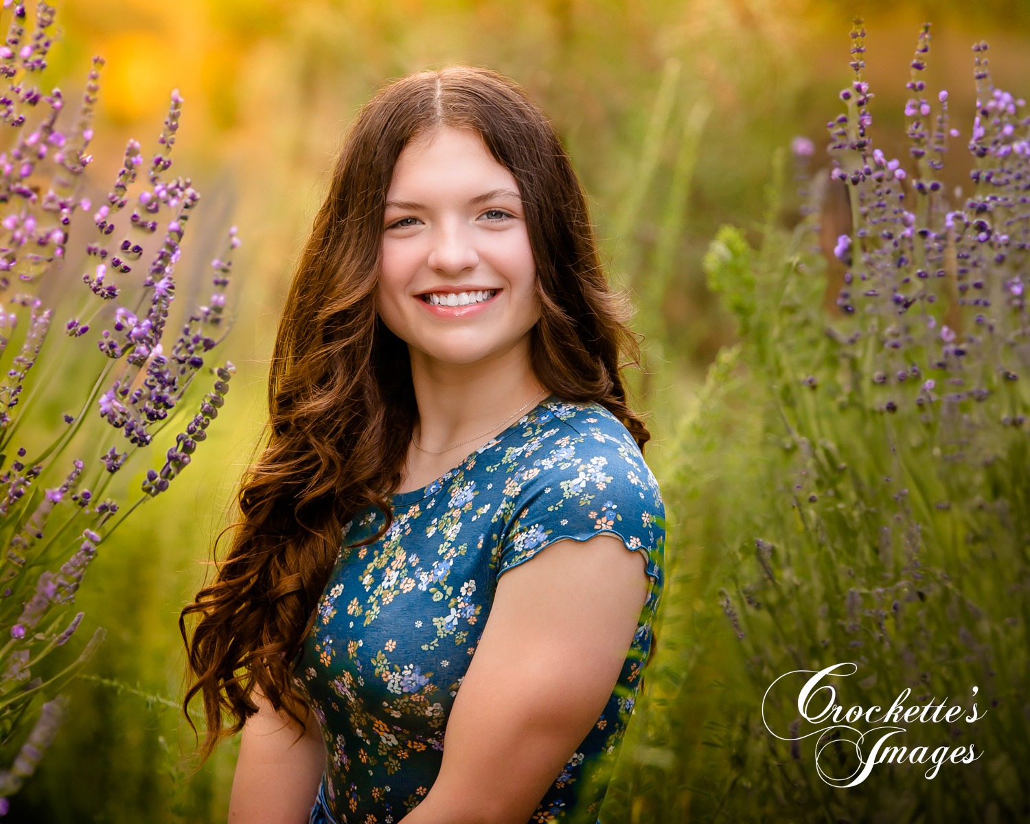 Dreamy classy senior girl photos with purple spring flowers and pine trees