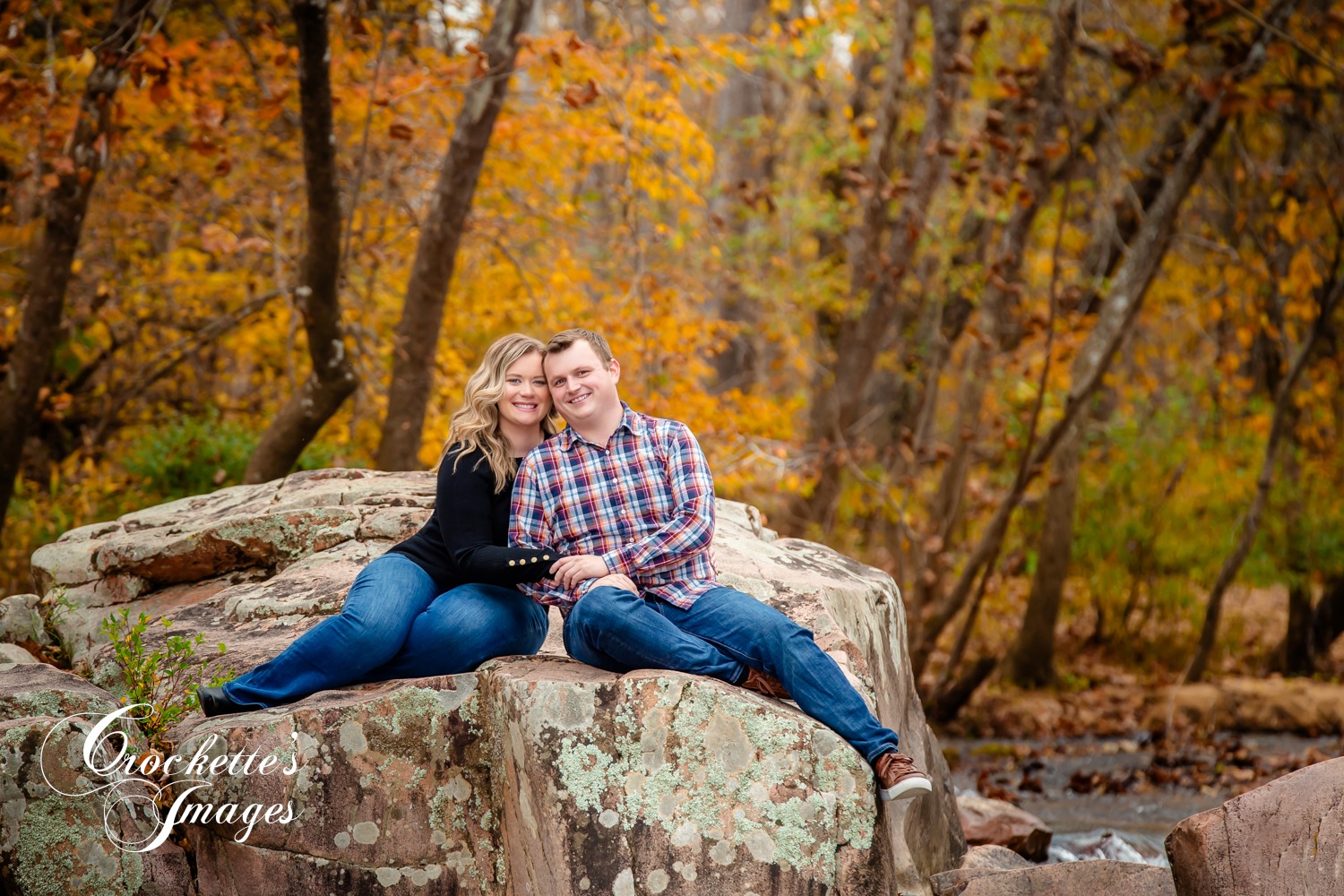 Fun, Classy, Fall Engagement Photos in a creek. Black and Plaid clothing color scheme.