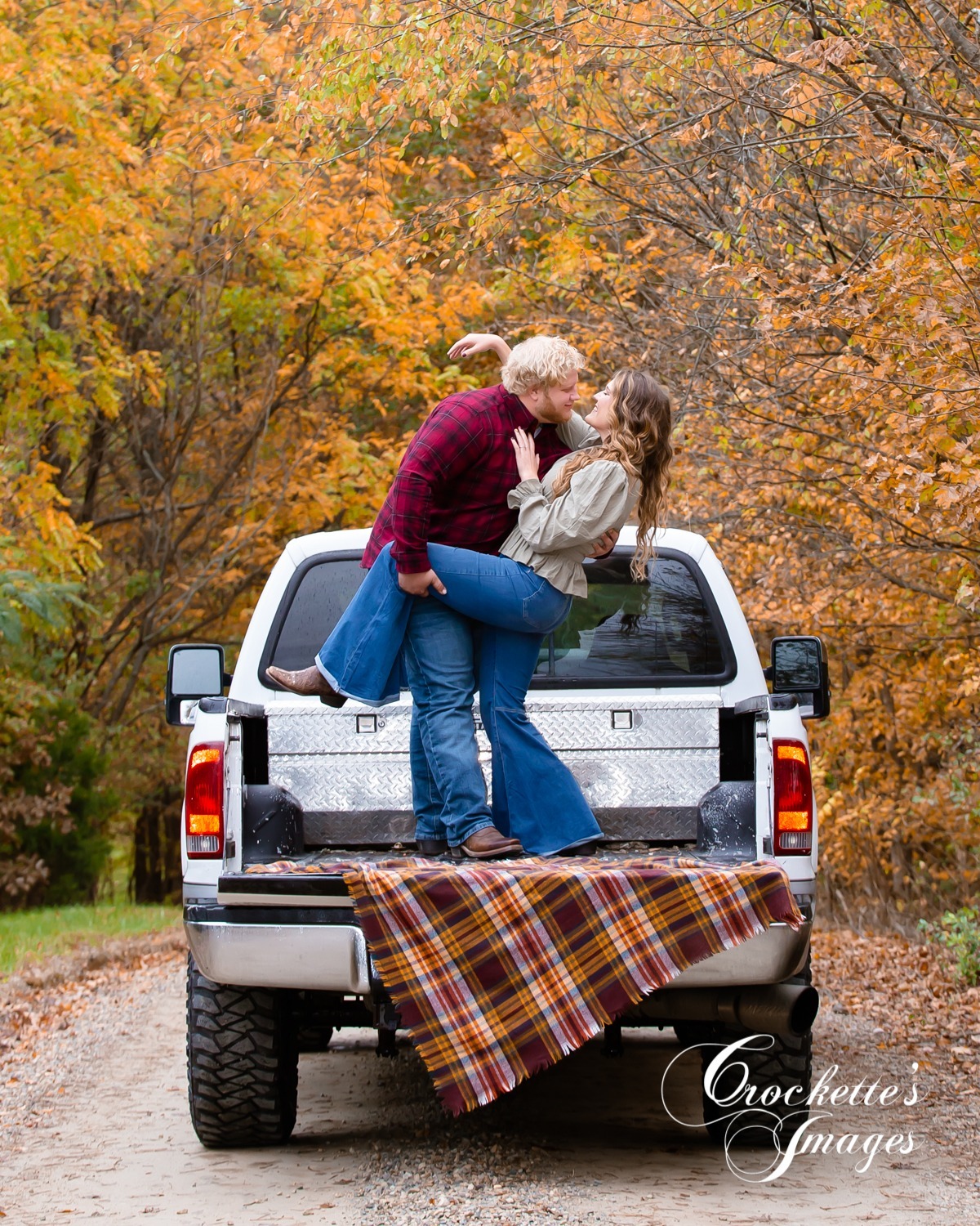 fun and emotional Fall Country Engagement Photos in Cape Girardeau, MO on a back country road with a pickup truck