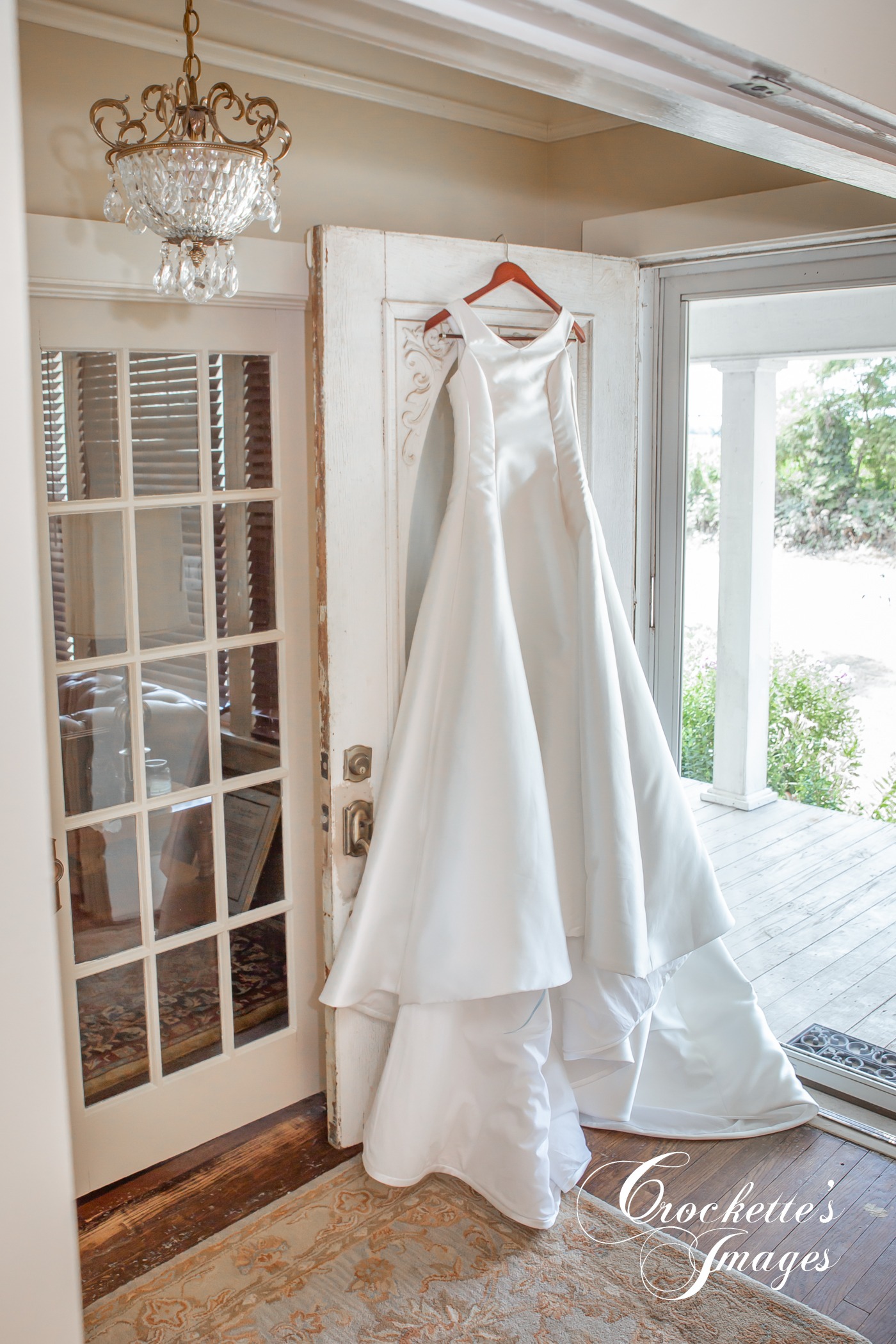 Elegant Wedding dress hanging on door