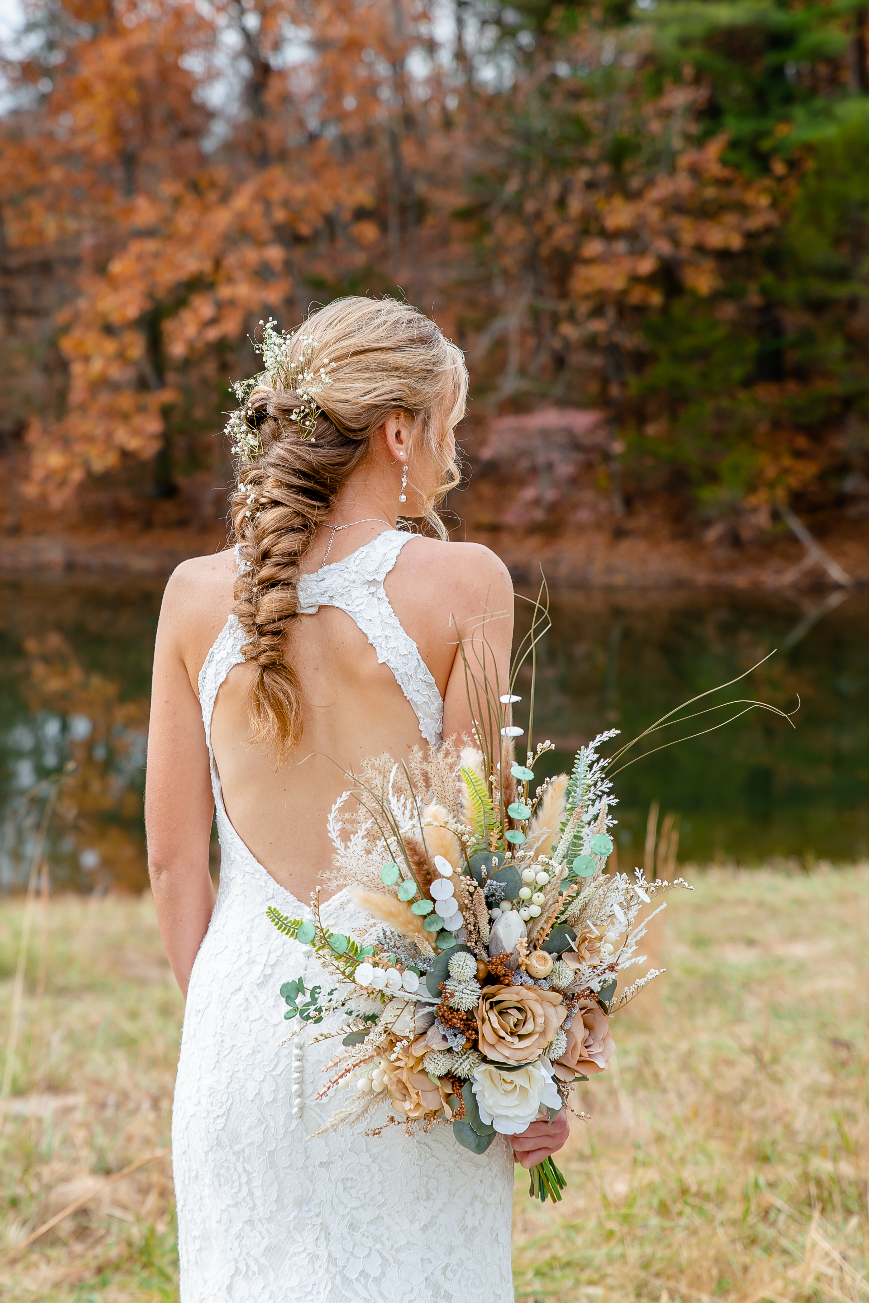 Country bride with rustic bouquet and flowers in her hair