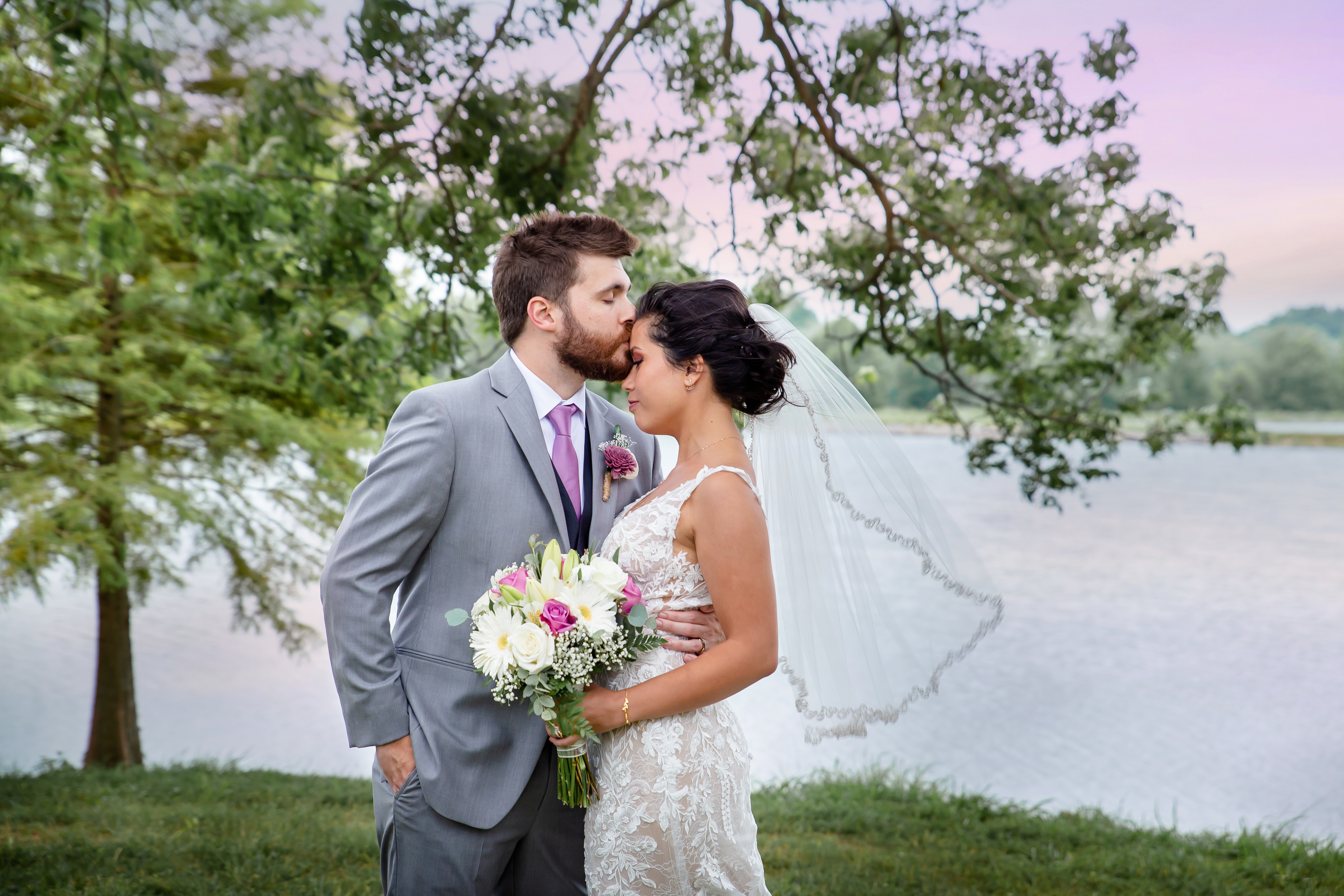 Wedding couple kissing at sunset at Waters Edge in Cape Girardeau,, MO.
