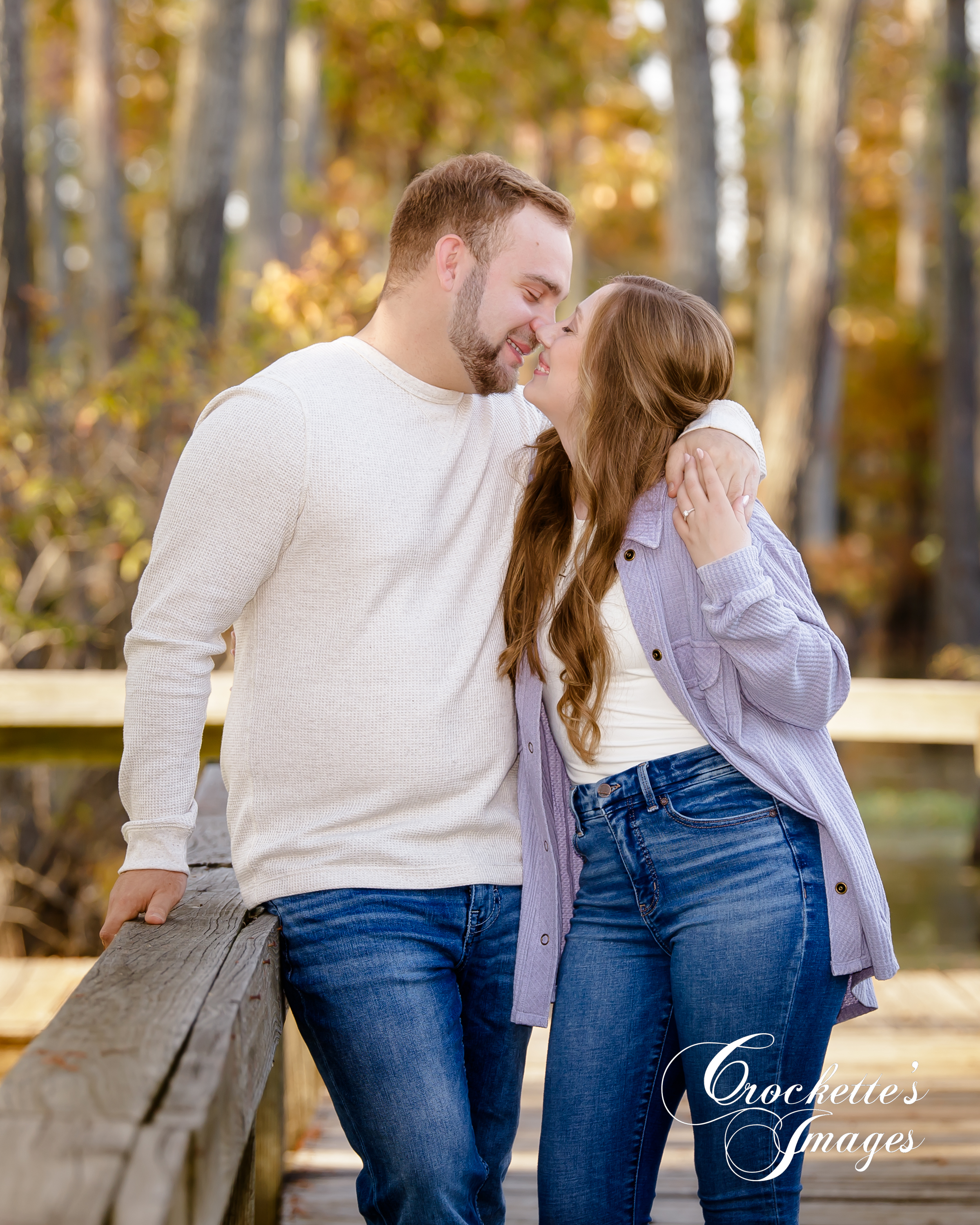 Romantic engagement photo of a couple on a dock