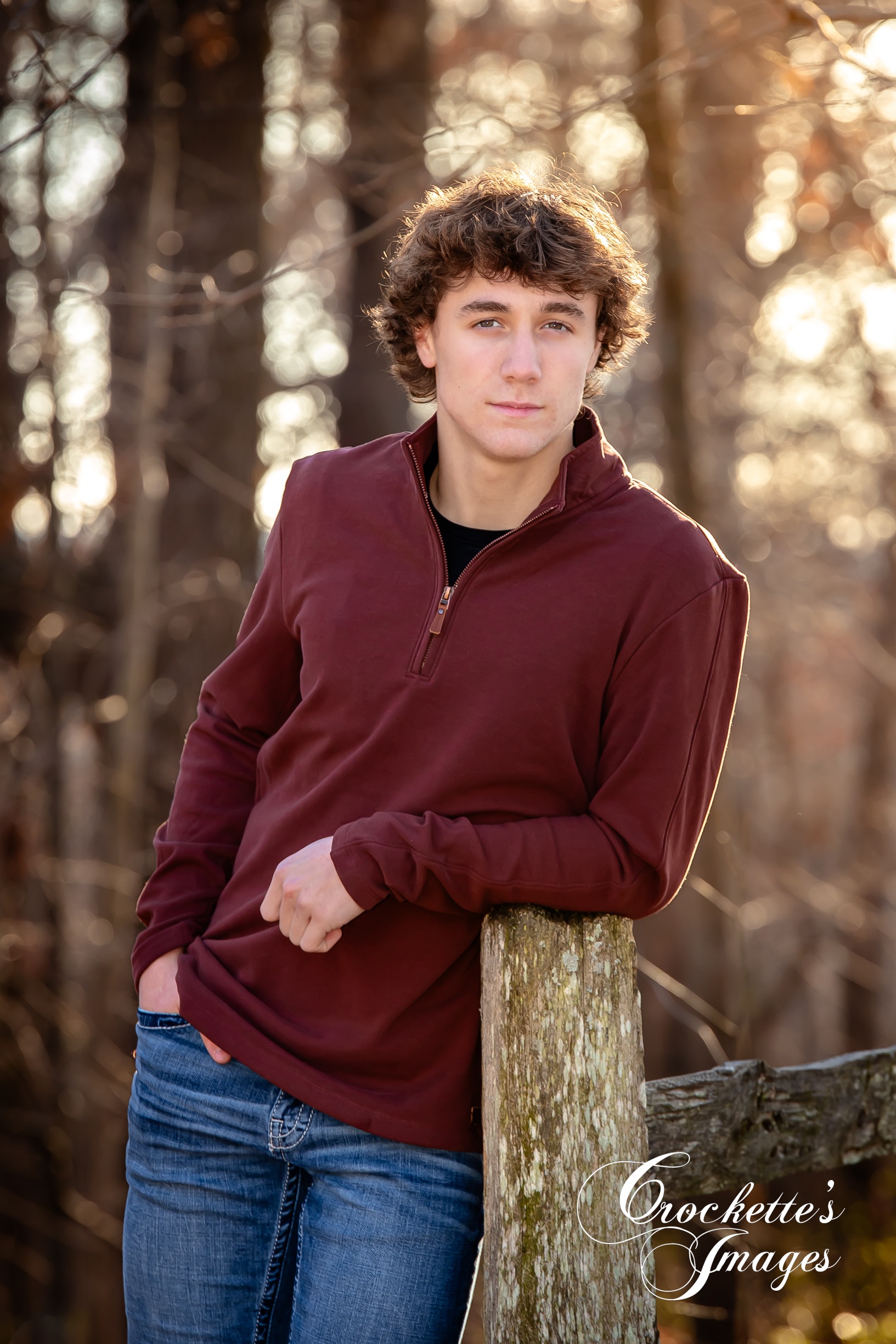 Handsome senior photo leaning against fence post