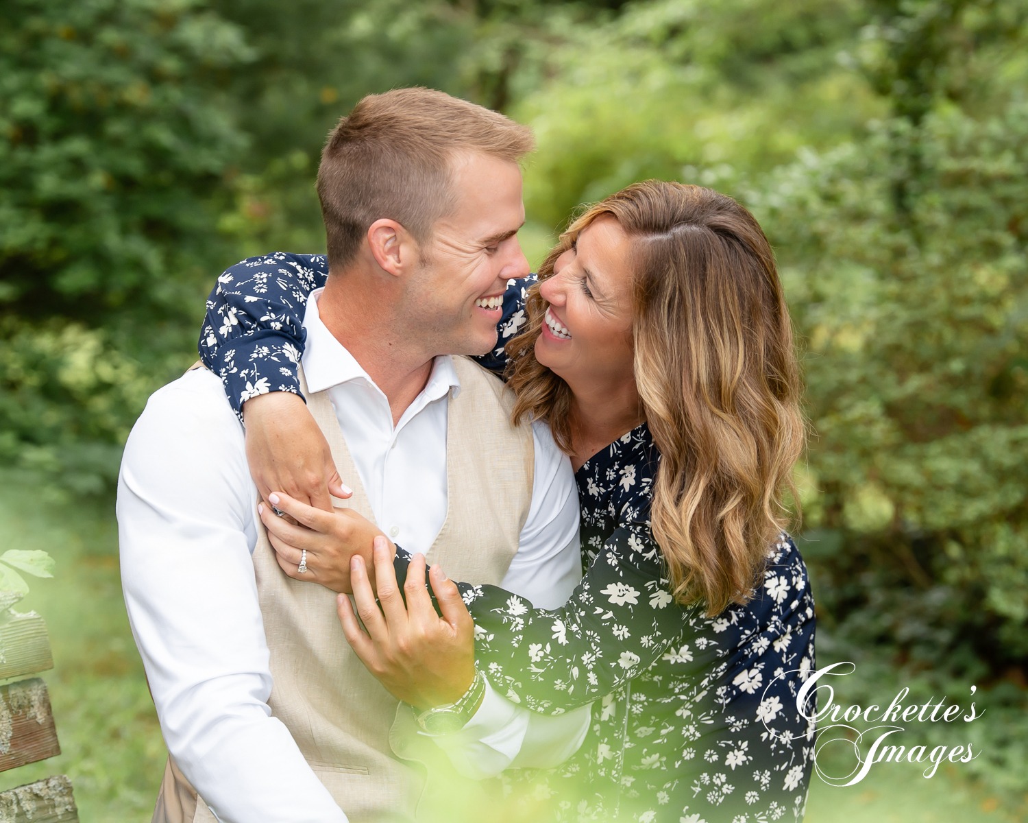 Super fun engagement photo with couple looking at each other laughing