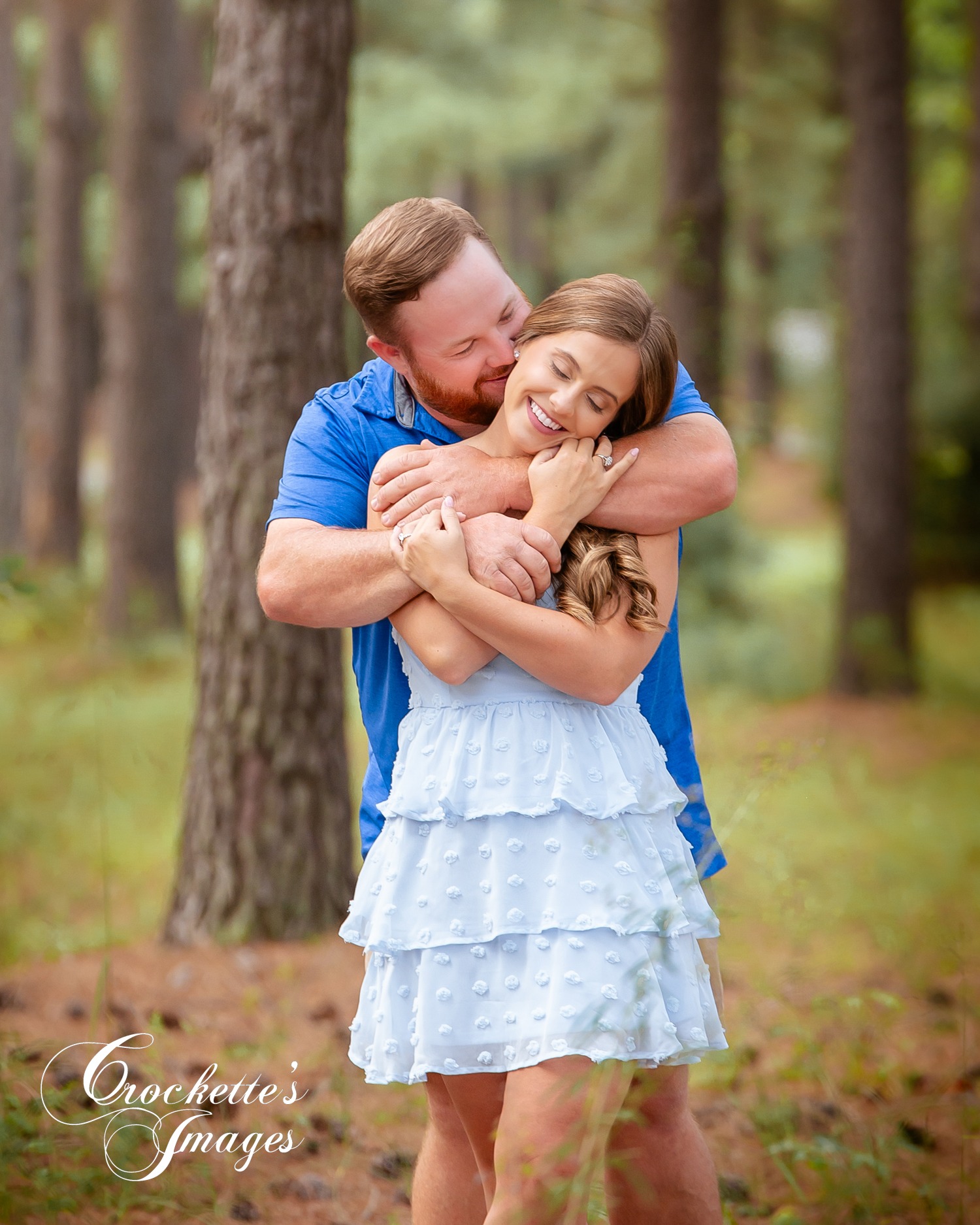 romantic engagement photo with couple hugging and kissing