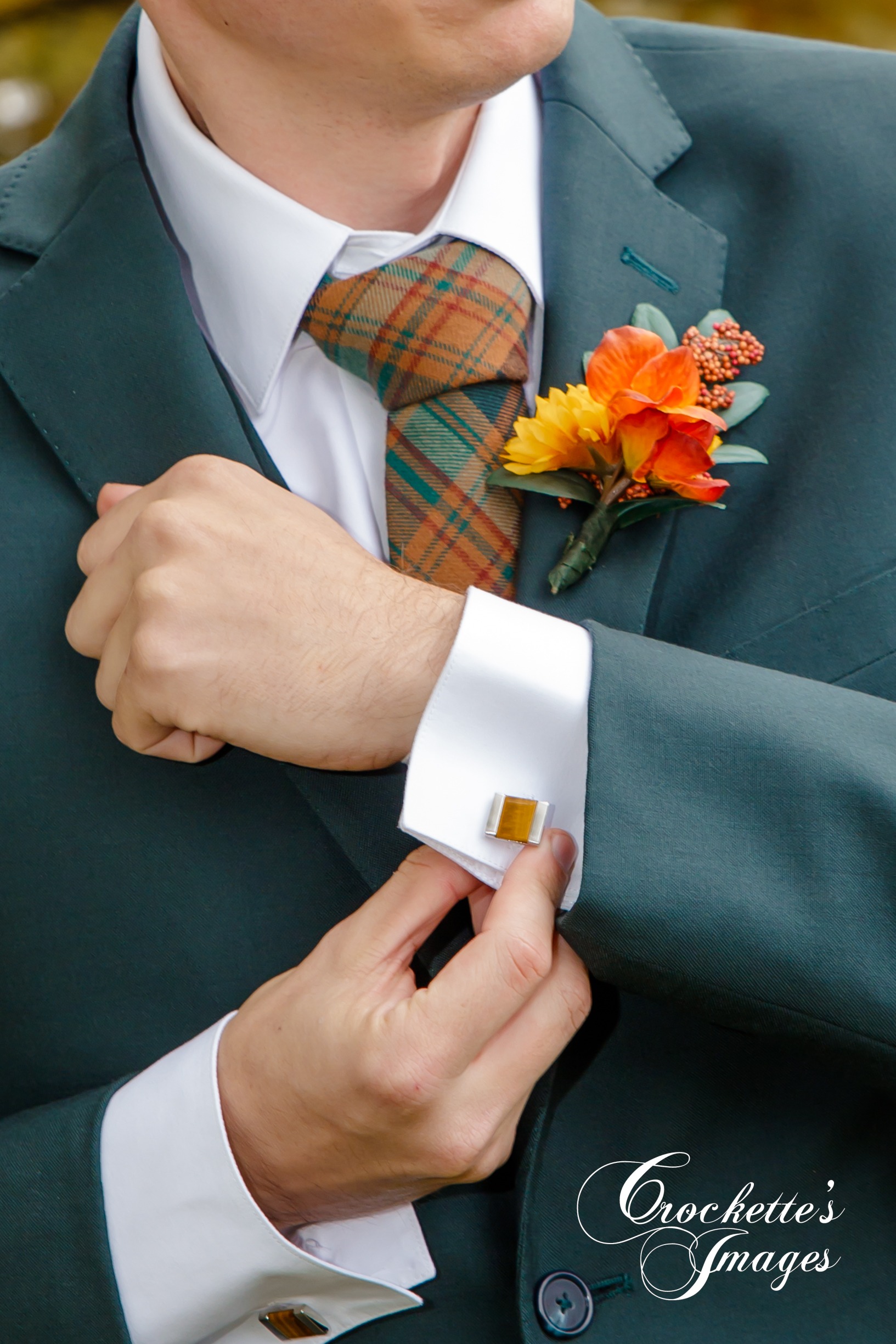 Groom adjusting cuflinks on his wedding day with Crockette's Images