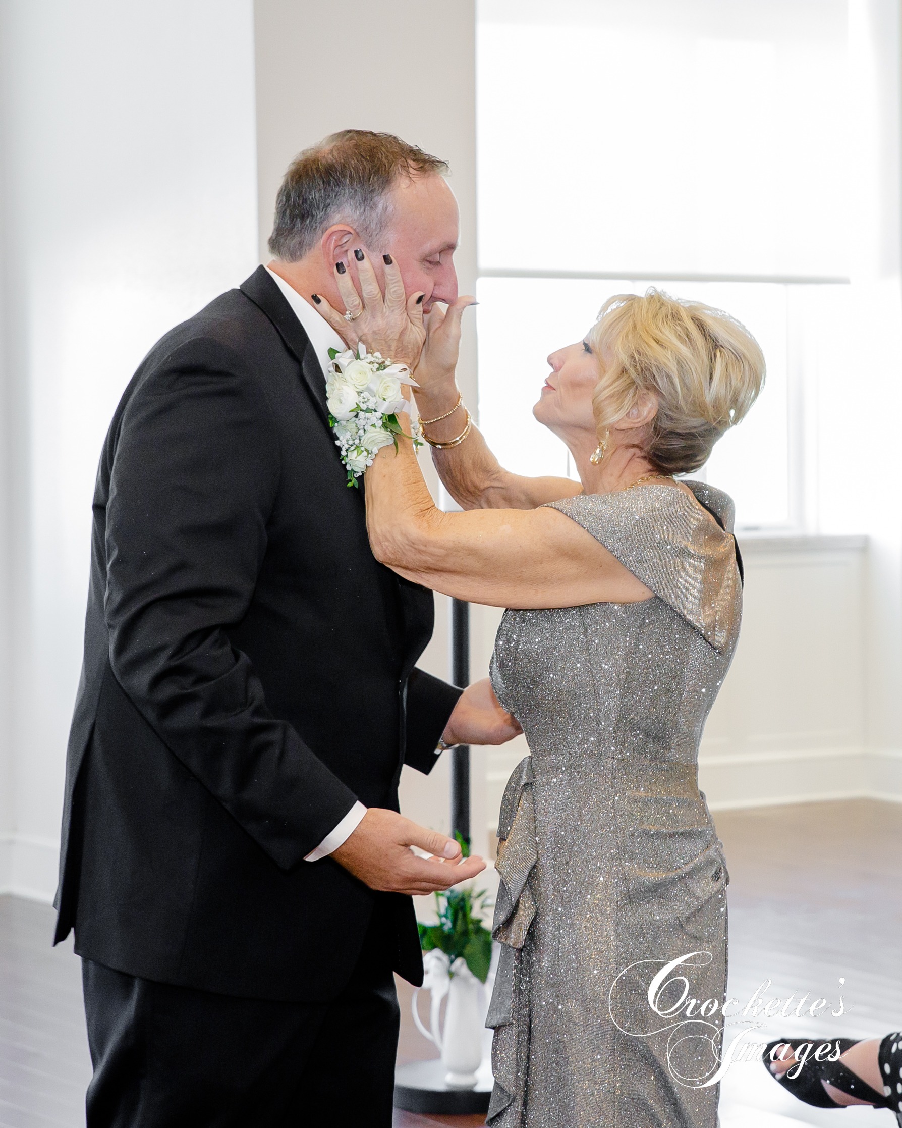 Mother of the groom embracing during ceremony at The River View Room downtown Cape Girardeau, MO