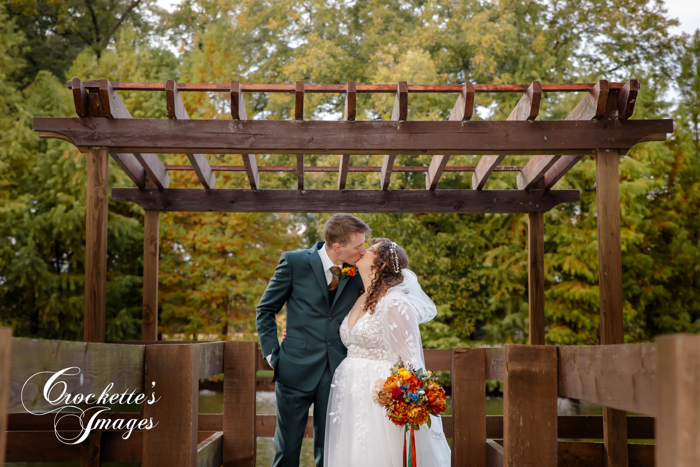 Bride & Groom kissing under gazebo at their fall wedding with Crockette's Images at Sweet Pecan