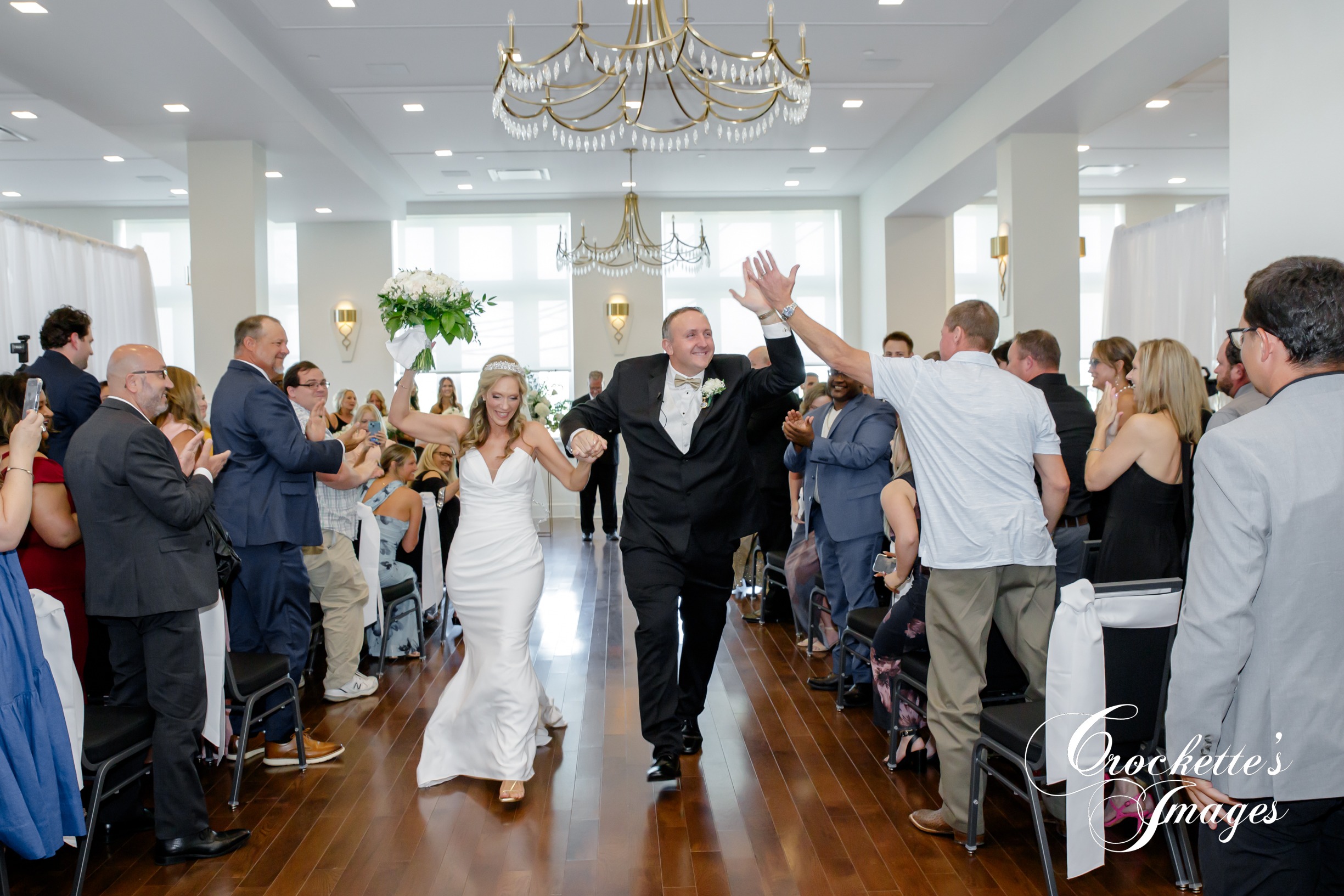 Bride & Groom celebrating down the asile at a ceremony at The River View Room downtown Cape Girardeau, MO