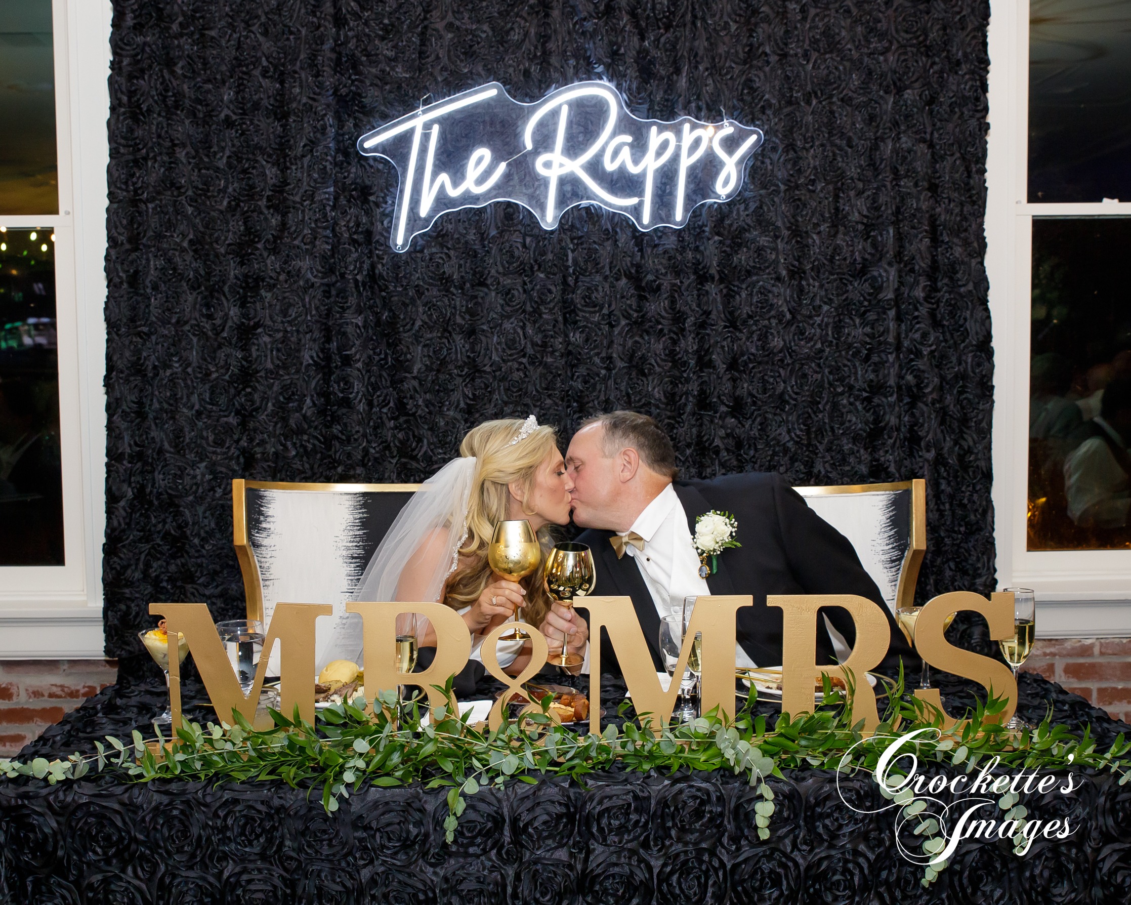 Bride & Groom kissing at head table at a Wedding Reception at The River View Room downtown Cape Girardeau, MO