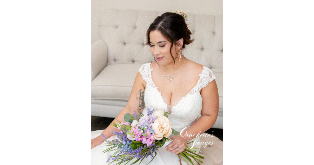 How to Pose With Your Bridal Bouquet for Timeless Wedding Photos You’ll Love Forever 6 Seated bride poses with her bridal bouquet as the photographer takes her photo from a bird's eye view.